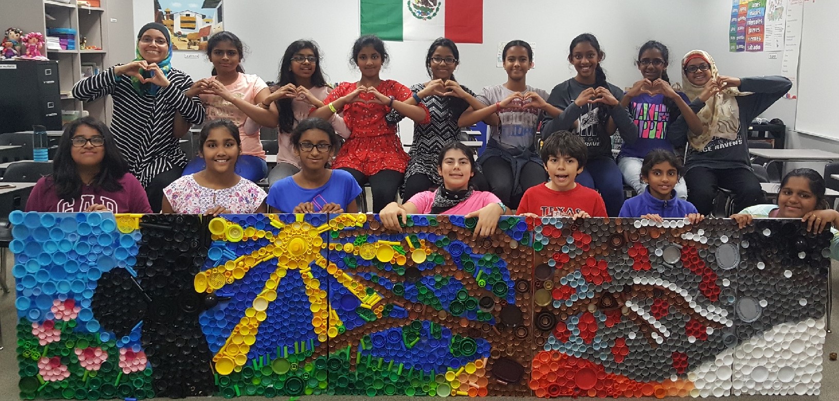 Club members holding  the mural 